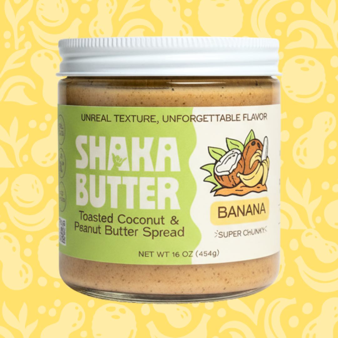 Jar of Shaka Butter Toasted Coconut & Peanut Butter Spread on a yellow background with banana illustrations