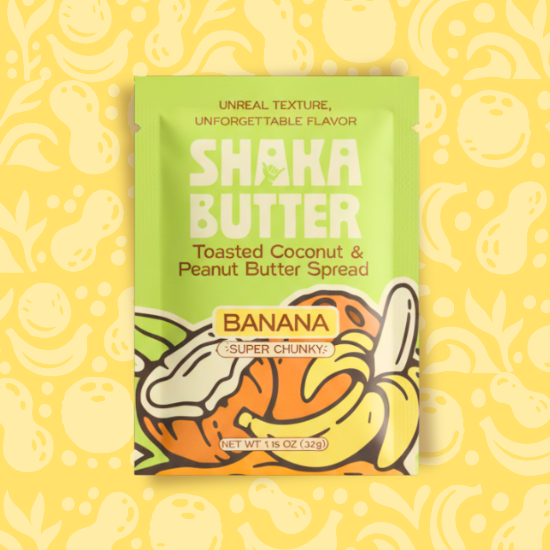 Shaka Butter Toasted Coconut & Peanut Butter Spread single serve packaging on a yellow background